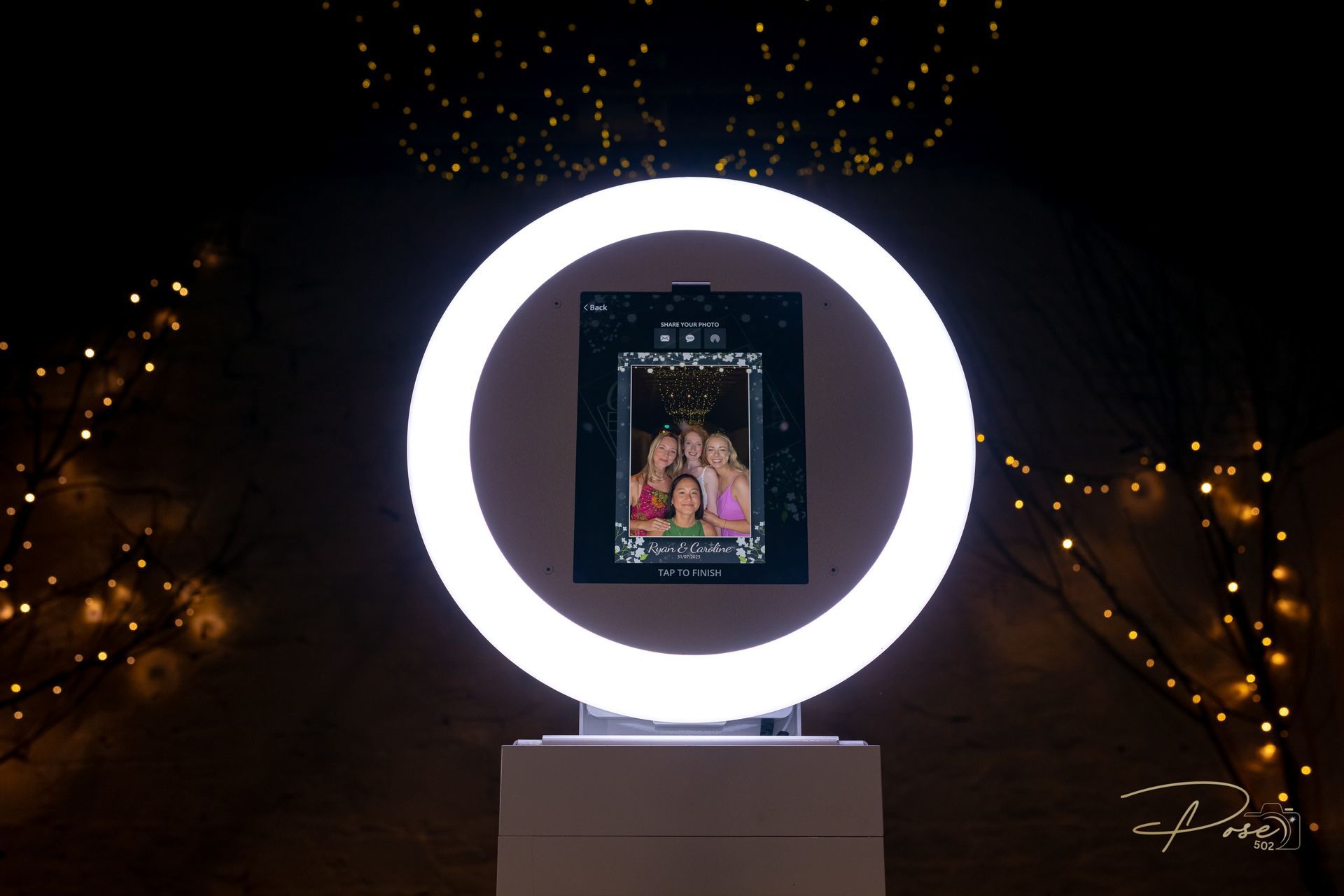 A photo booth with a ring light in the middle of it.