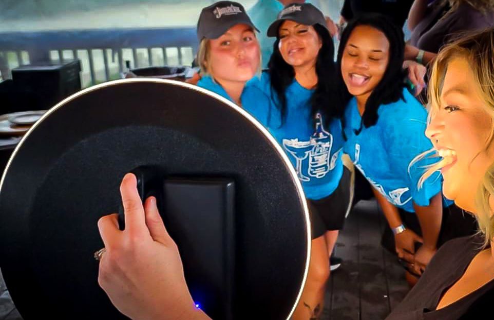 A woman is taking a picture of a group of people