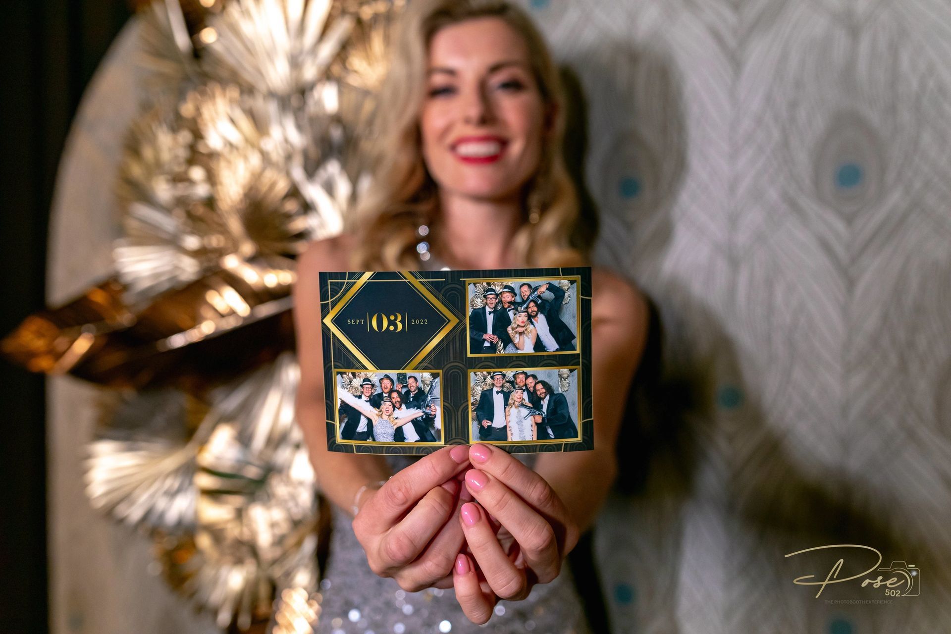 A woman is holding a card with a picture of a bride and groom on it.