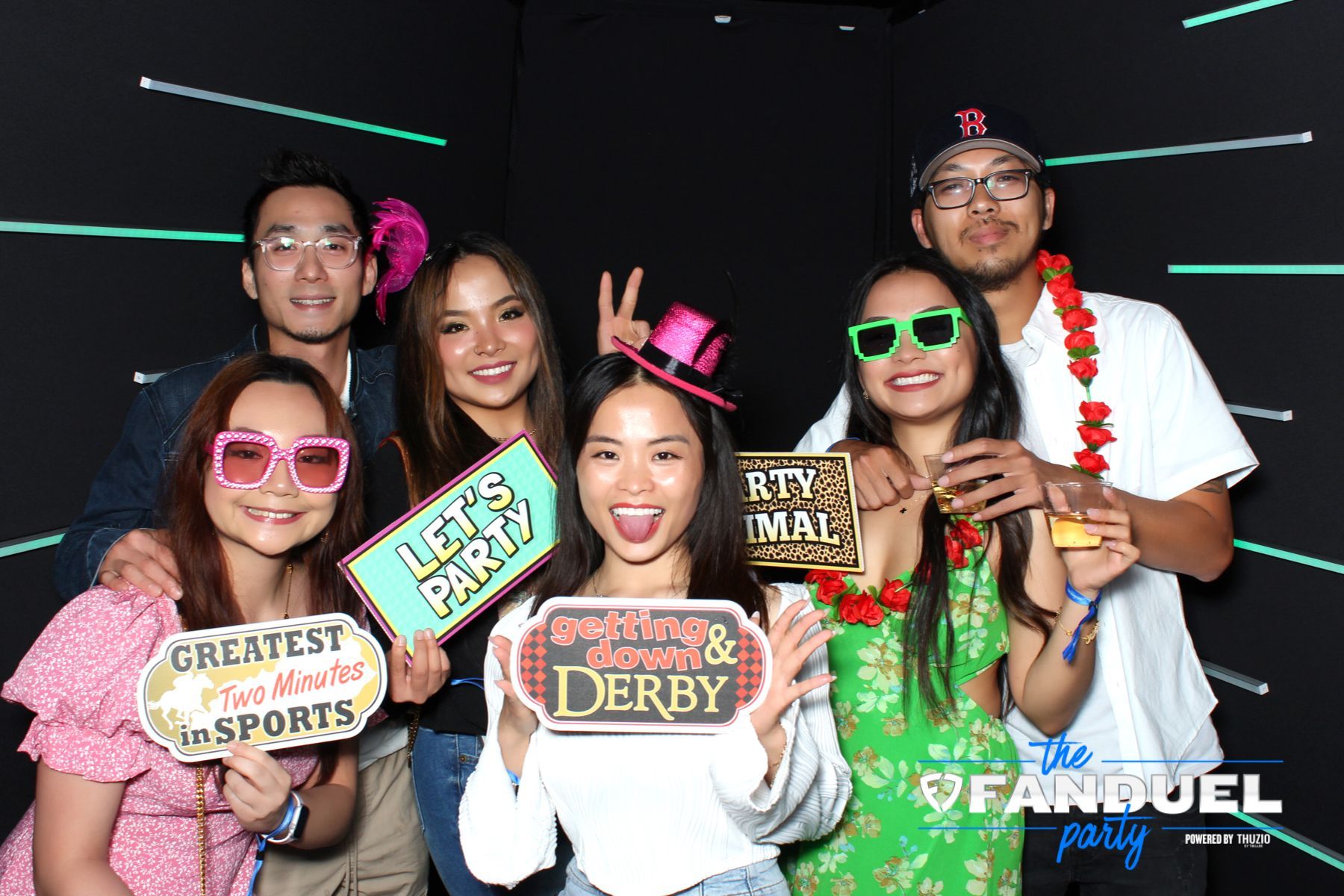 A group of people are posing for a picture in a photo booth.