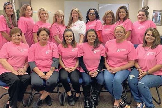 group of women in breast cancer awareness t-shirts