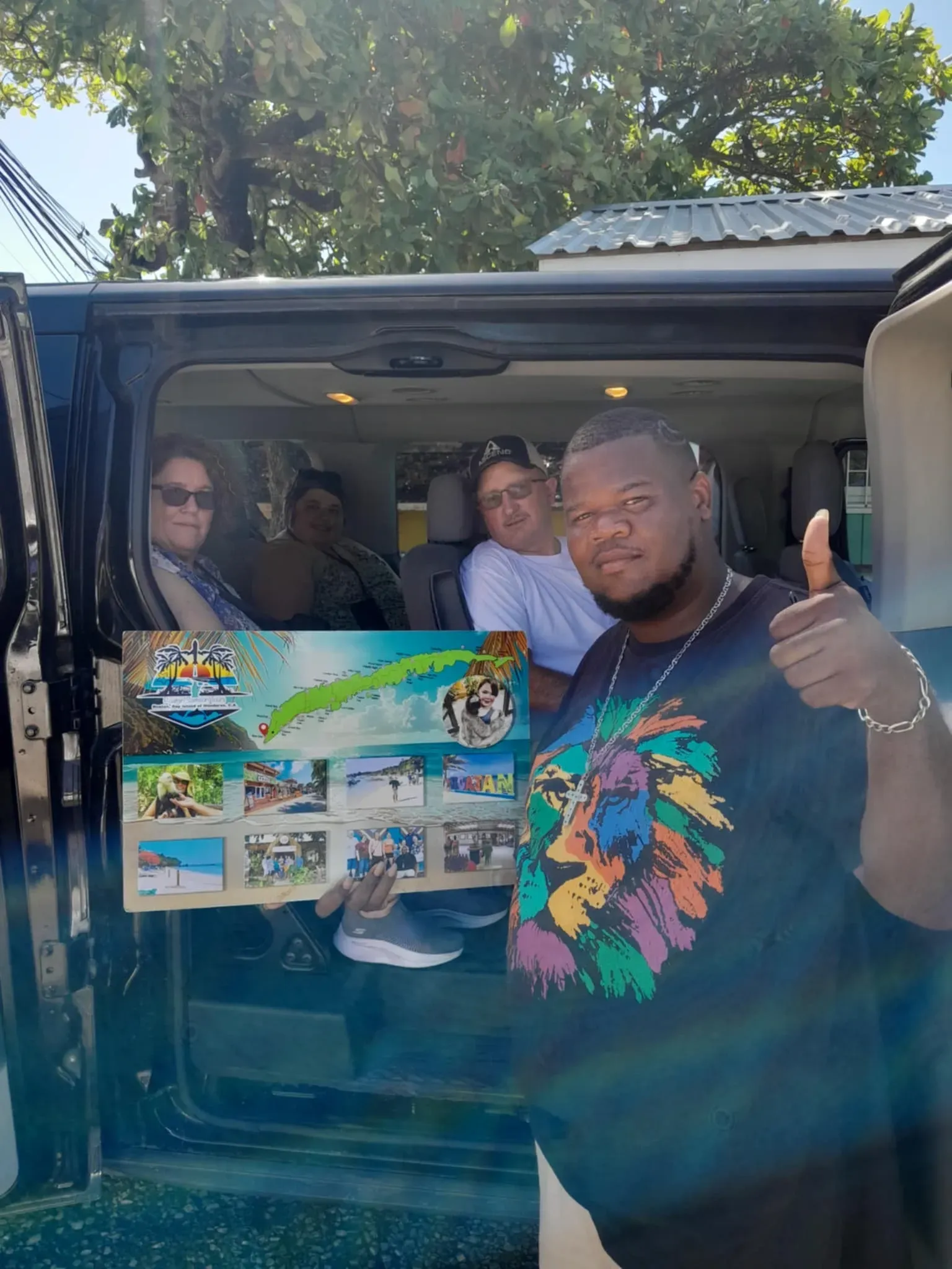 A man is giving a thumbs up while standing in the back of a van.