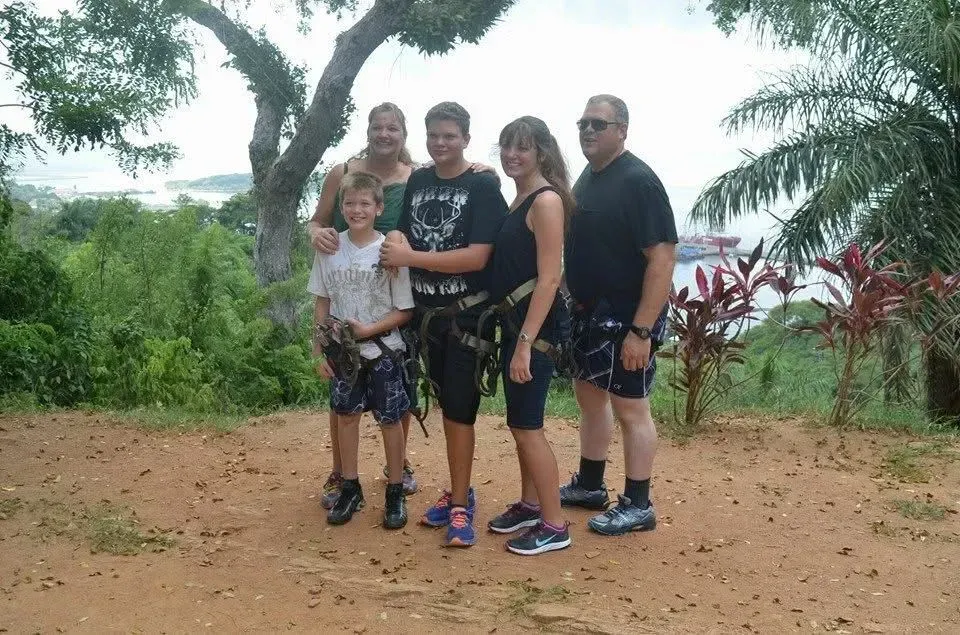 A group of people posing for a picture in front of a tree