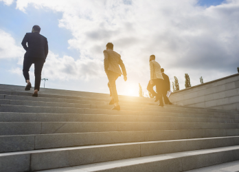 A group of people are walking up a set of stairs.