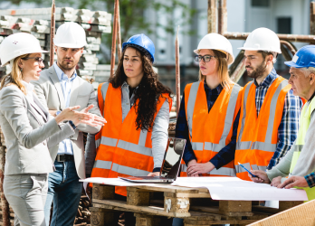 Corporate and safety team meeting at construction site
