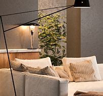 A living room with a couch and a lamp.