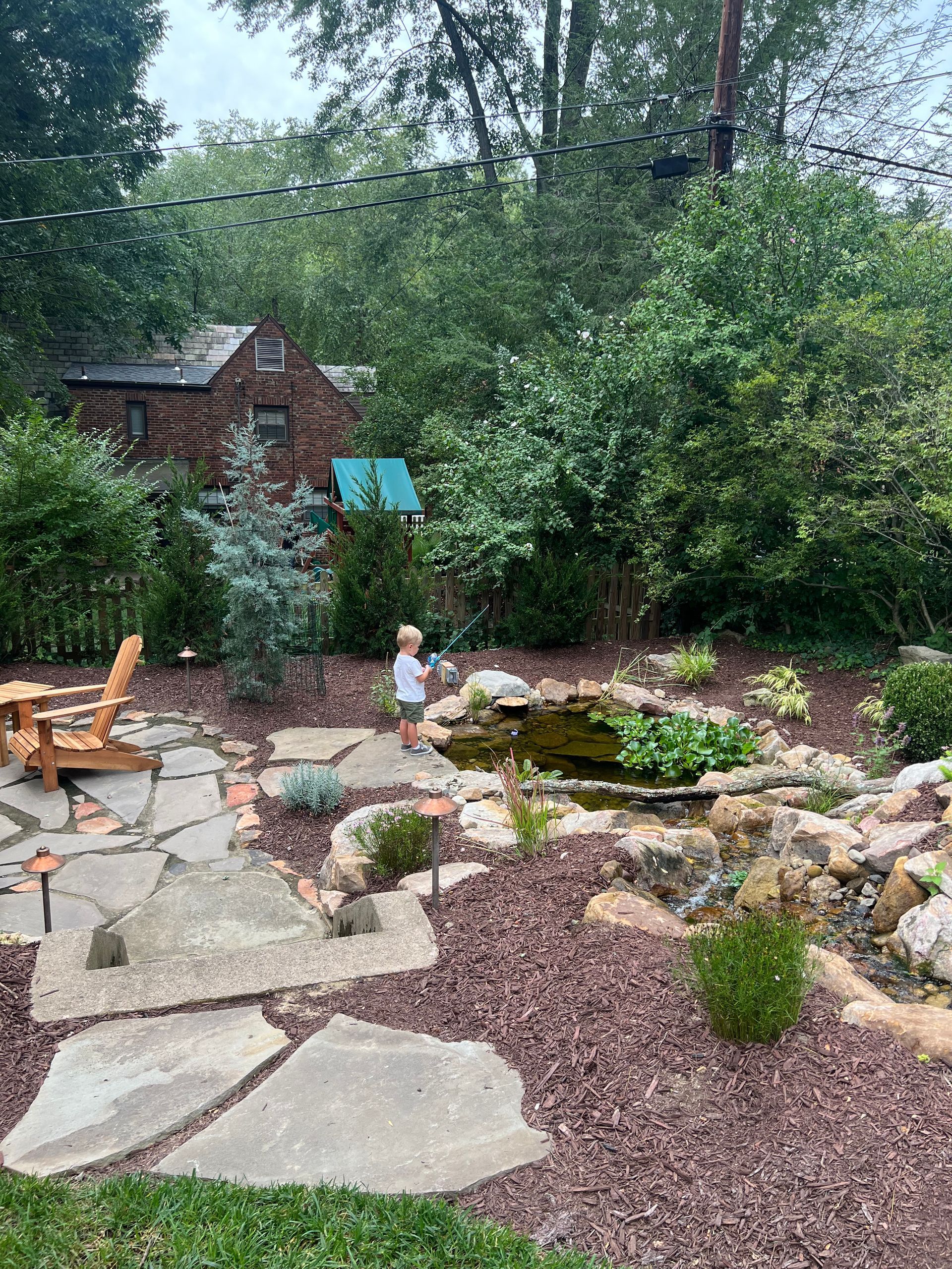 Patio and pond installed by Gramm Outdoor - Little boy