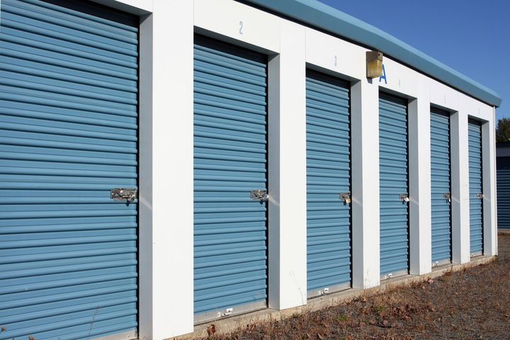 A row of blue garage doors with the number 2 on the top