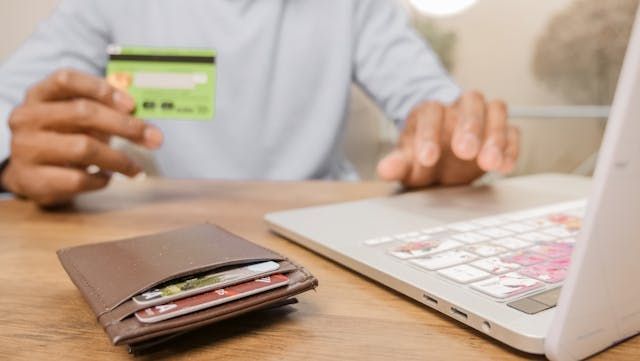 Person holding a credit card to make an online payment