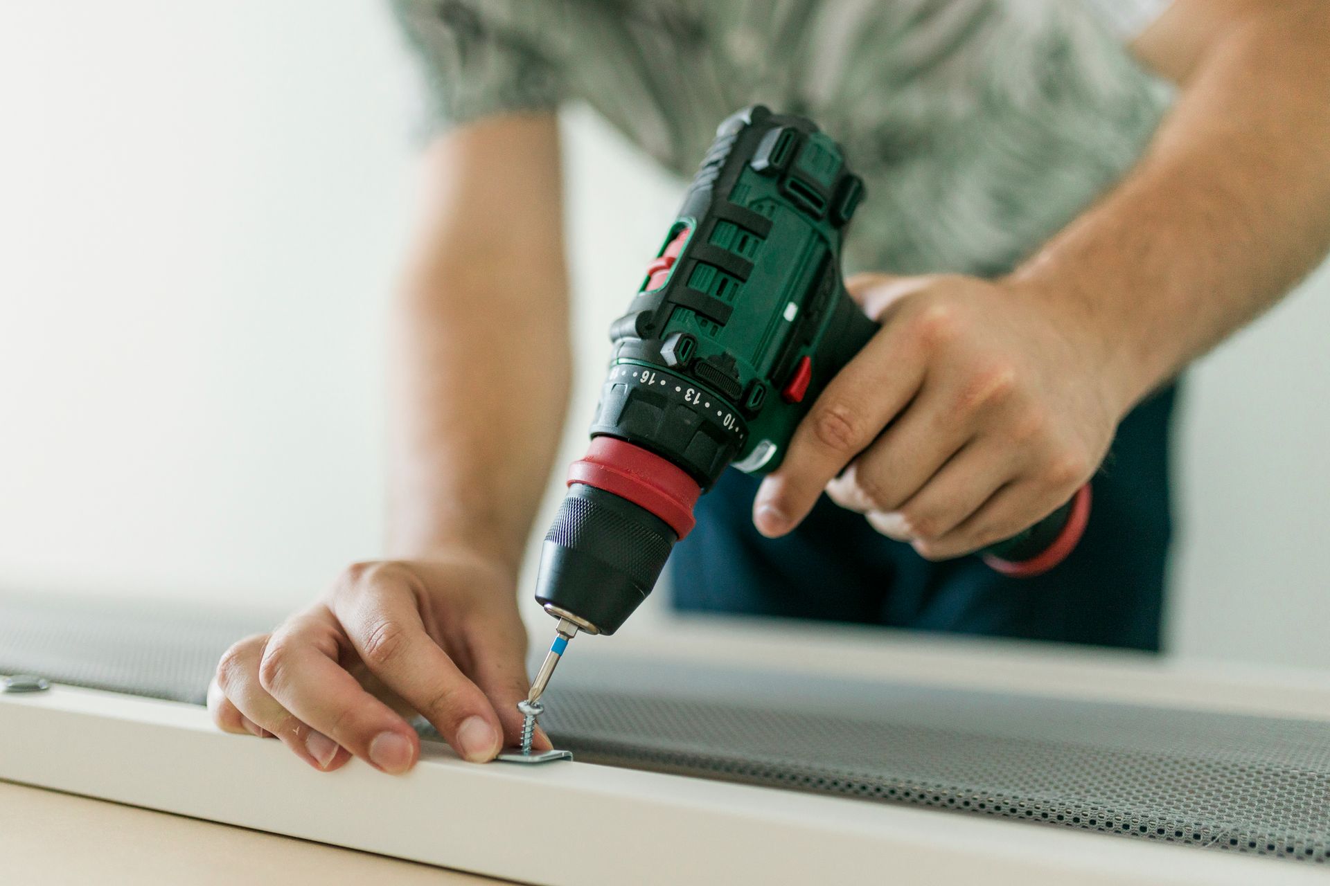 a contractor using an electric drill
