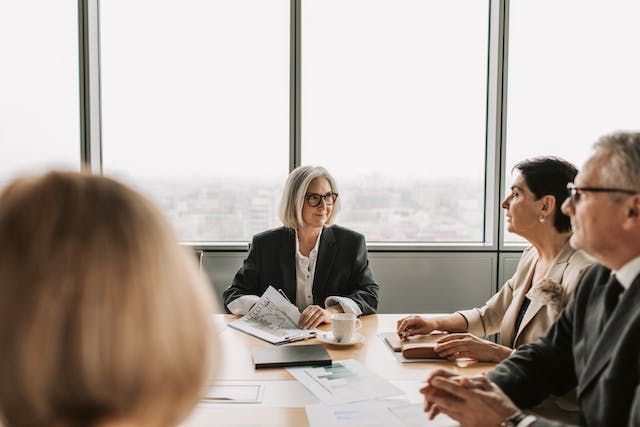 a group of people in a conference room during a business meeting