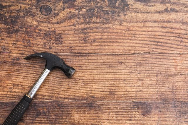 a hammer on a wood table