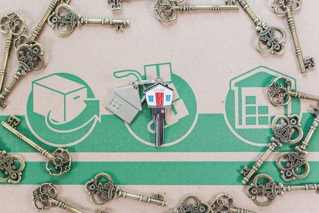 a house key on a moving box surrounded but other keys