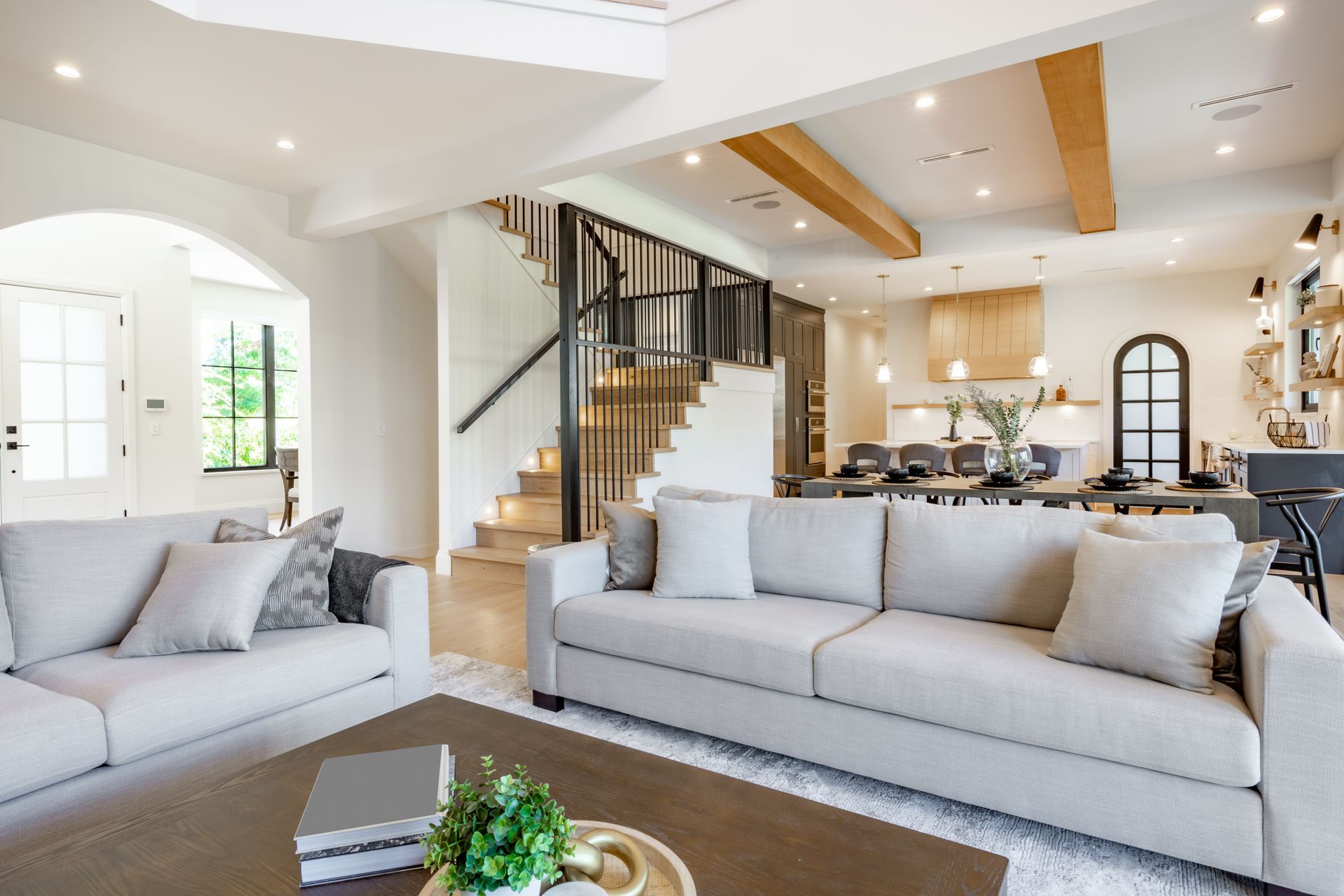 a modern living and dining room with white and lightwood accents