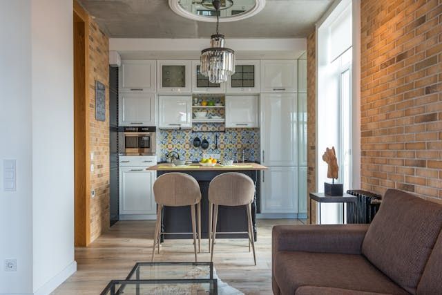 a small apartment kitchen with a yellow and blue backsplash