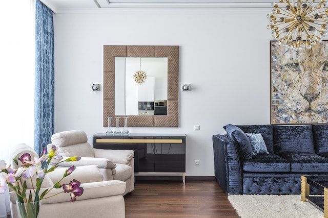 living room with two arm chairs and blue velvet couch