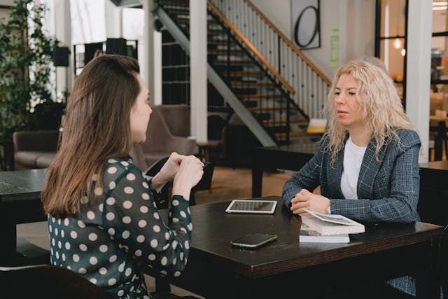 two people talking at a living room table