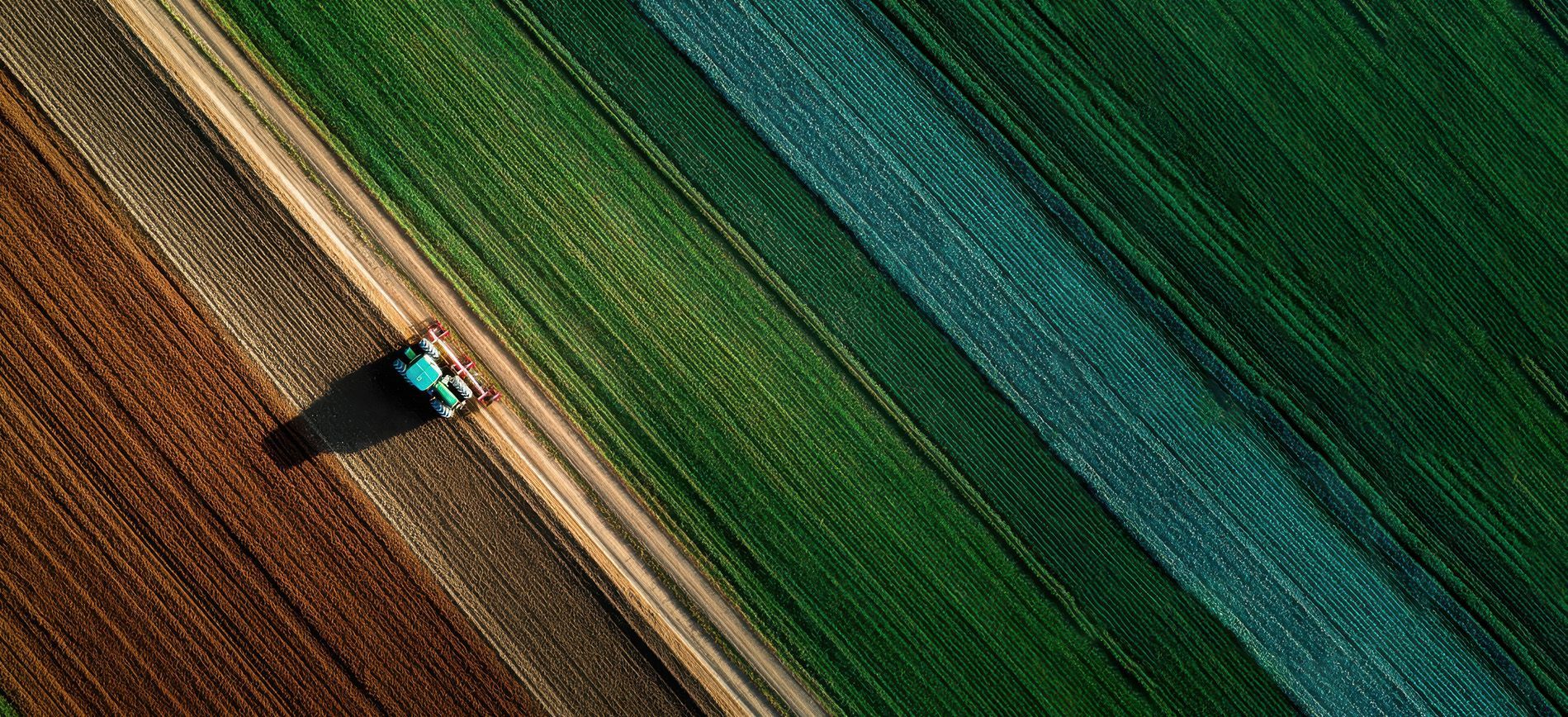 GPS-guided tractor applying fertilizer in zones based on a digital nutrient map.