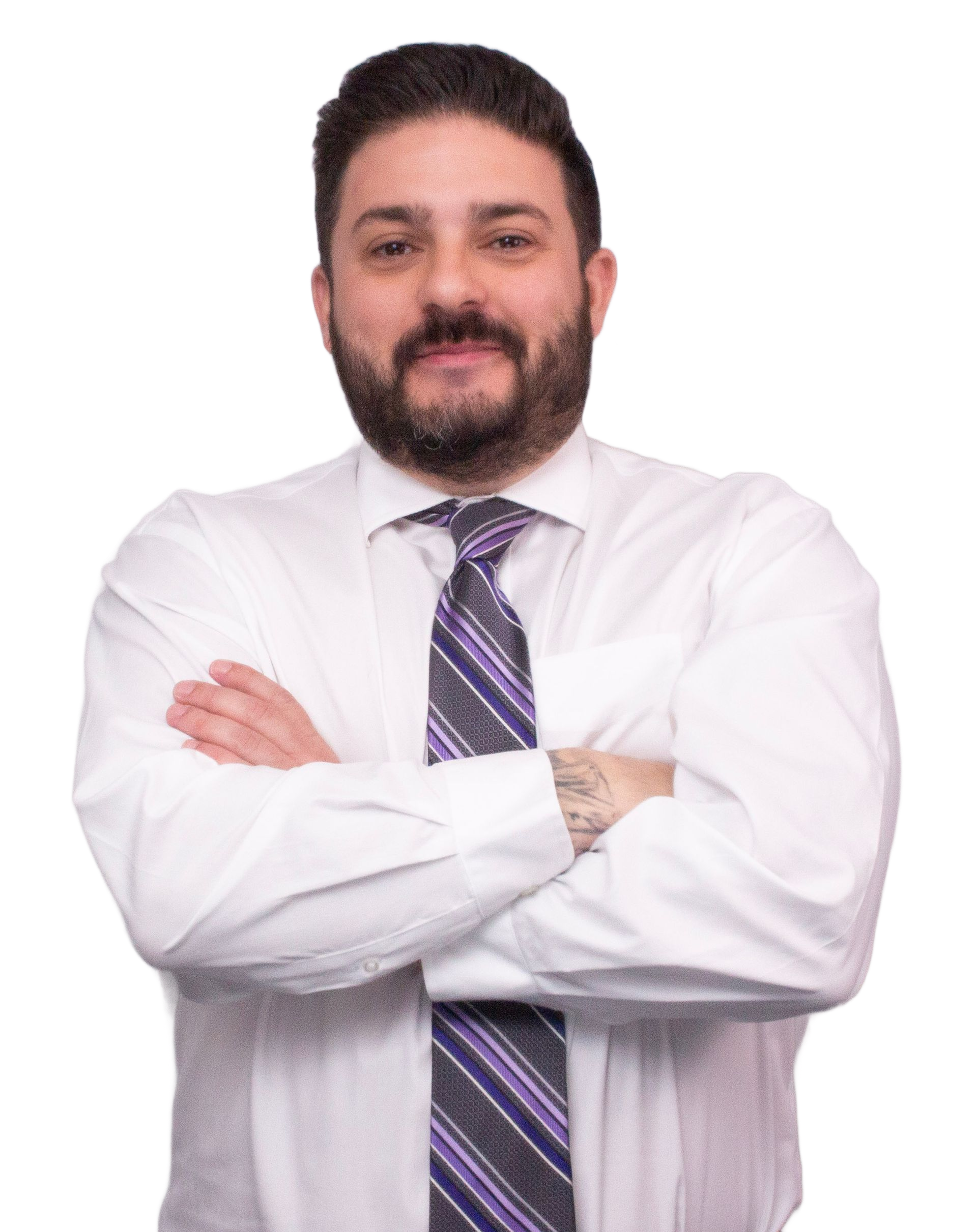 Daniel De Liguori in white shirt and tie with arms crossed, smiling.