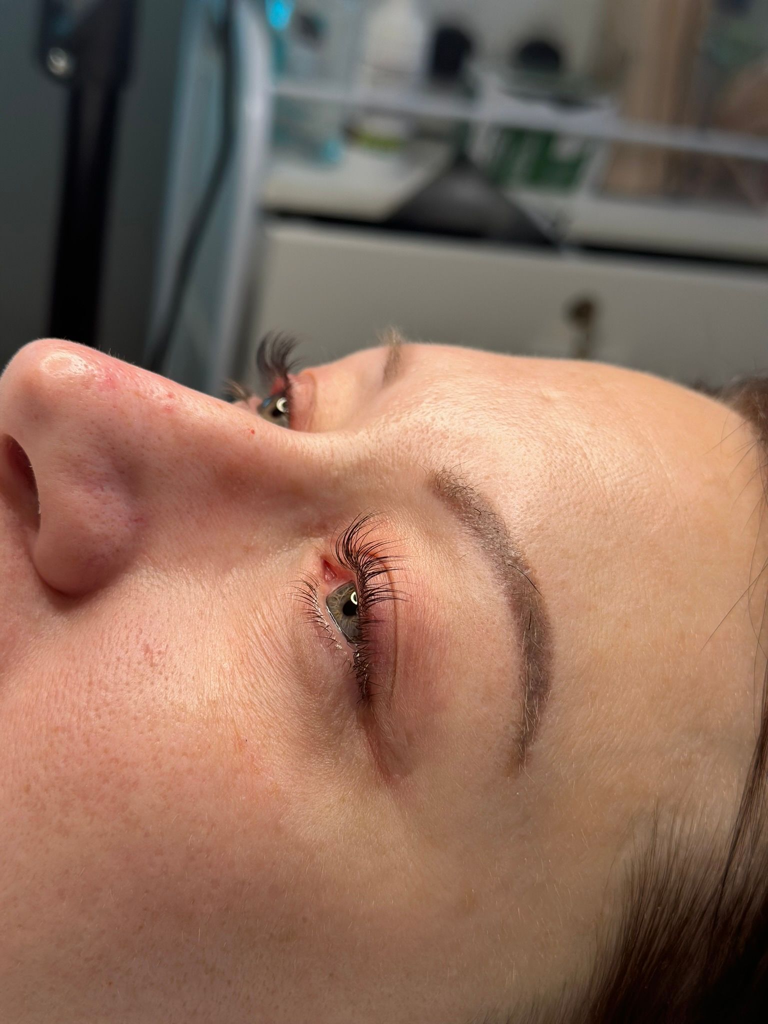Close-up of a person's eye and eyebrow. Freshly done permanent eyeliner with some swelling.