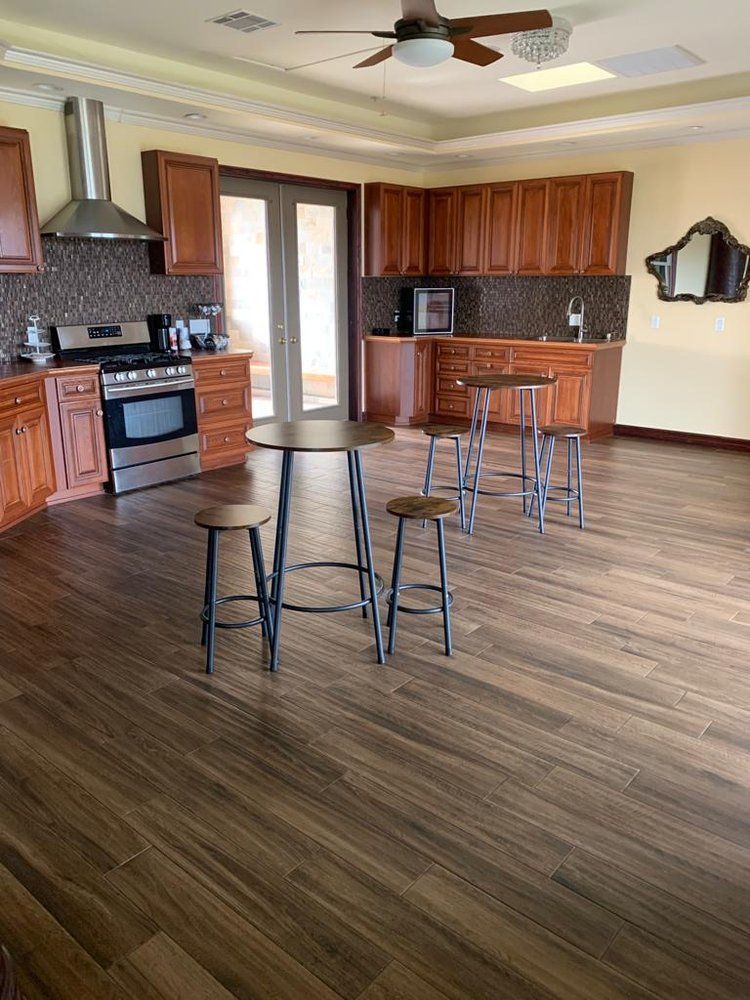Kitchen with wood cabinets, tile backsplash, stainless steel appliances, and bar seating.