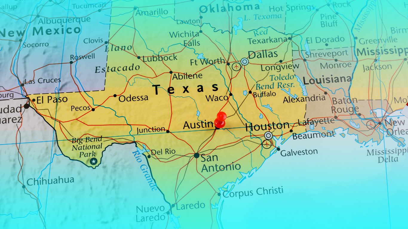 A man in a construction vest doing taxes for a construction business in the woodlands, tx.