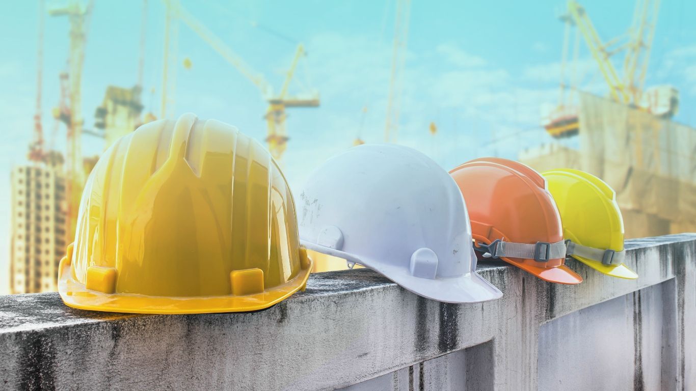 Construction workers hard hats, symbolizing worker classification and compliance.