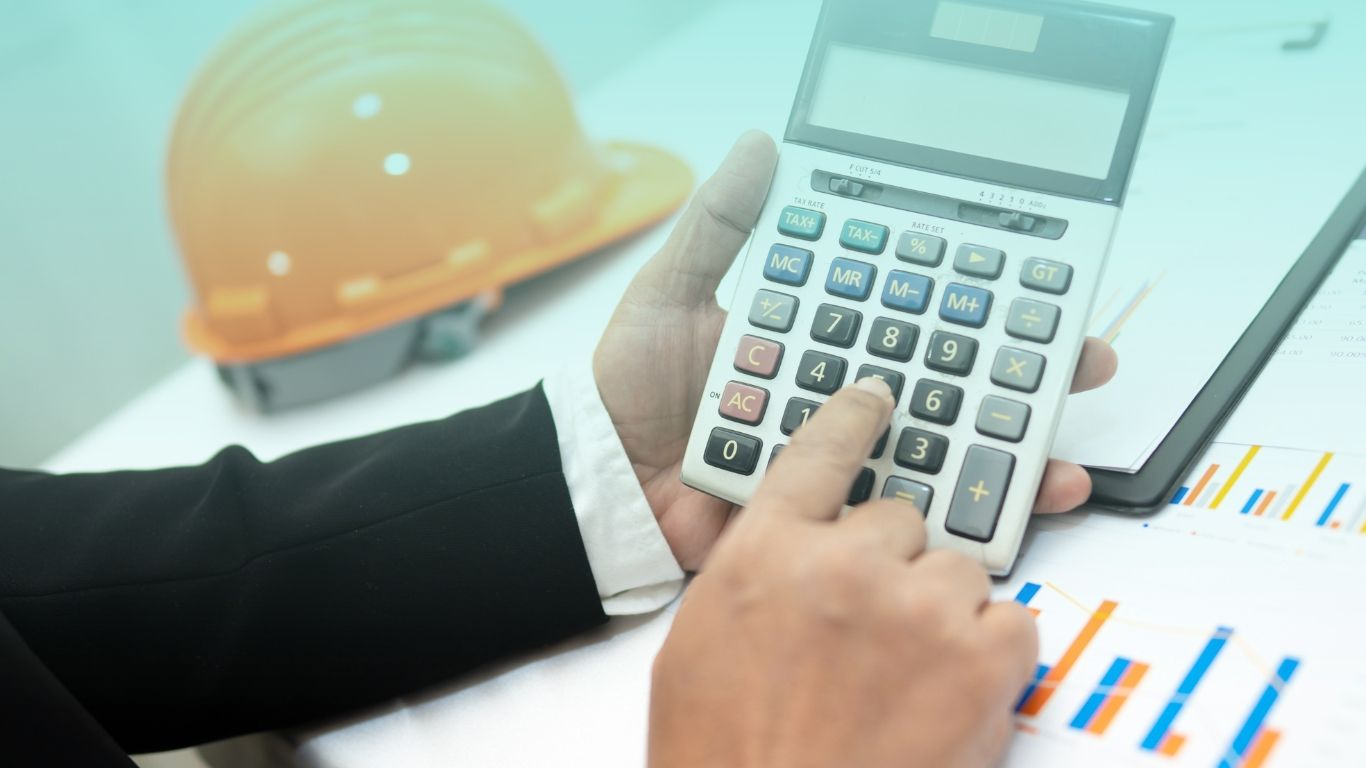 Construction blueprints and financial documents, illustrating project-based accounting services.