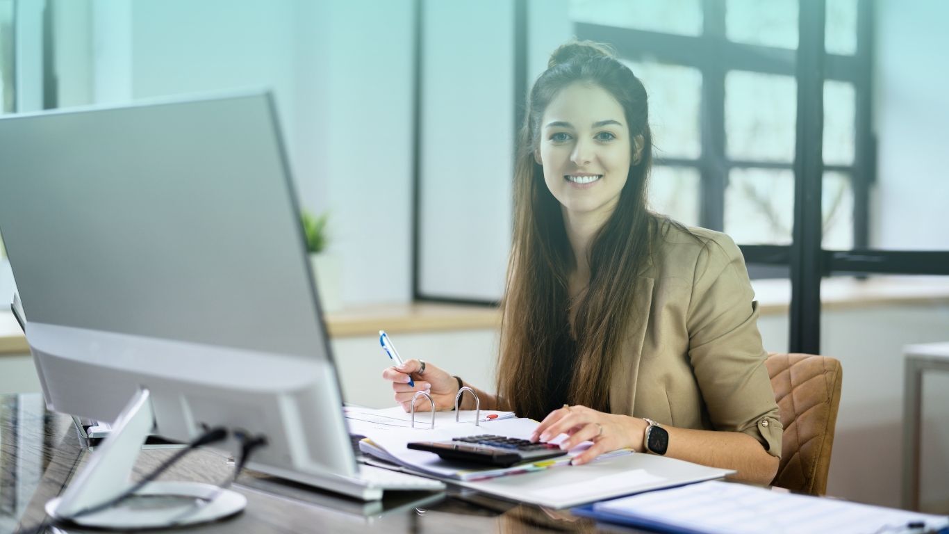 A tax professional at her desk representing passive activity loss rules and strategies for active participation in real estate.