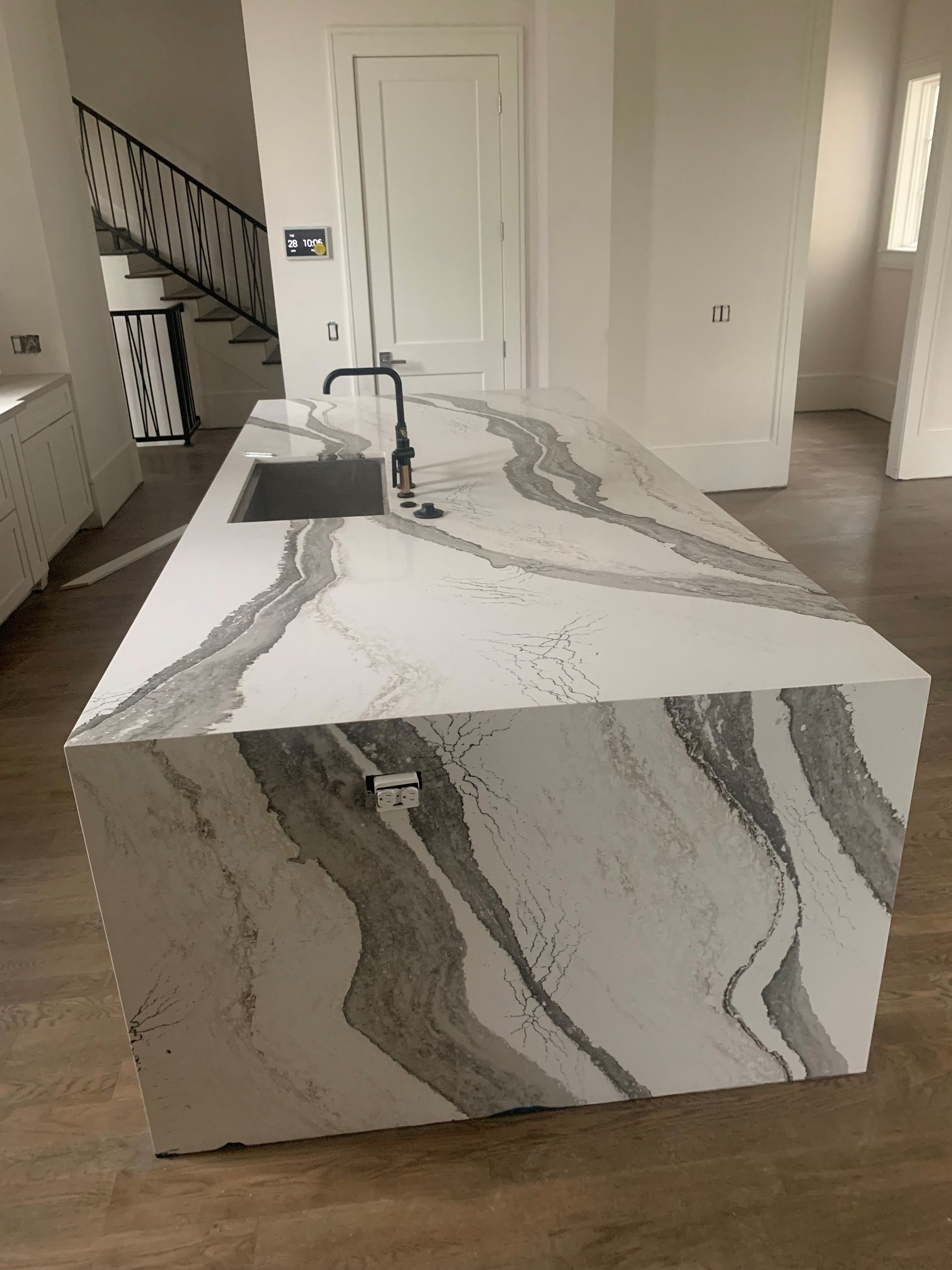 A kitchen with a large island and a sink