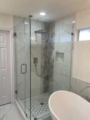 A bathroom with a walk in shower and a bathtub