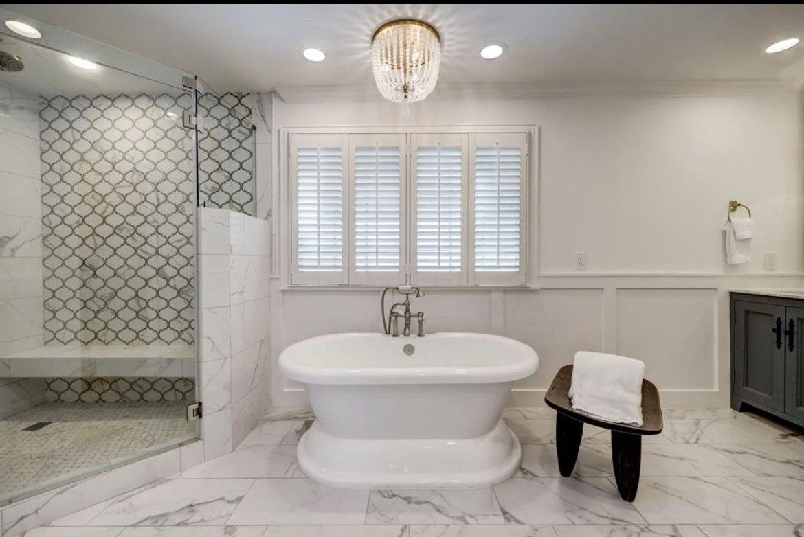 There is a bathtub in the middle of the bathroom