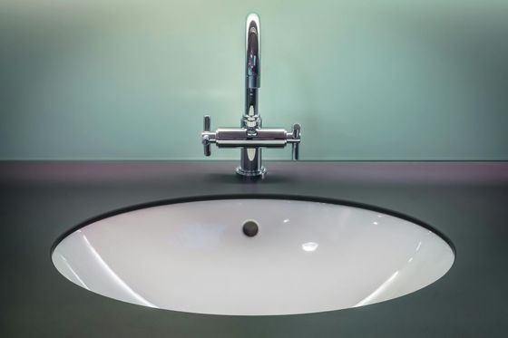 A bathroom sink with a faucet on top of it