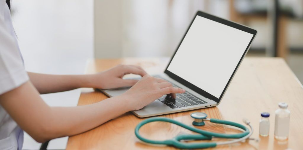 A Medical Professional Typing on a Laptop — Tewantin Medical Centre In Tewantin, QLD