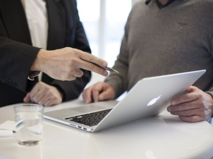 Two Men Looking at a Laptop, One Points to the Screen — Tewantin Medical Centre In Tewantin, QLD