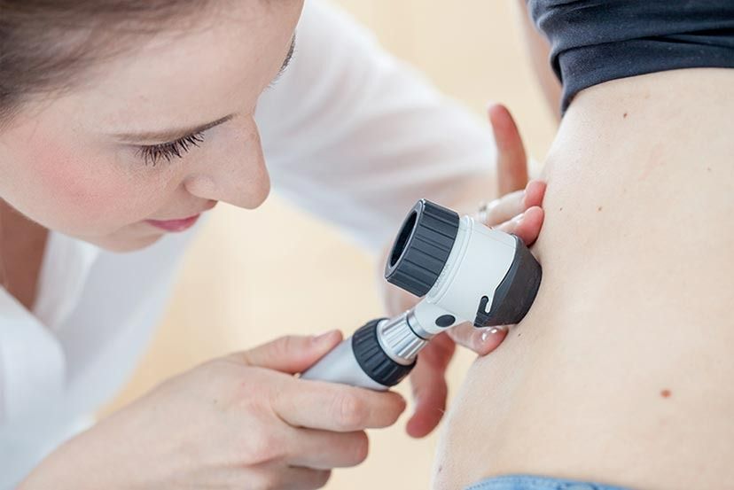 Dermatologist examining a patient's skin for potential skin conditions — Tewantin Medical Centre In Tewantin, QLD