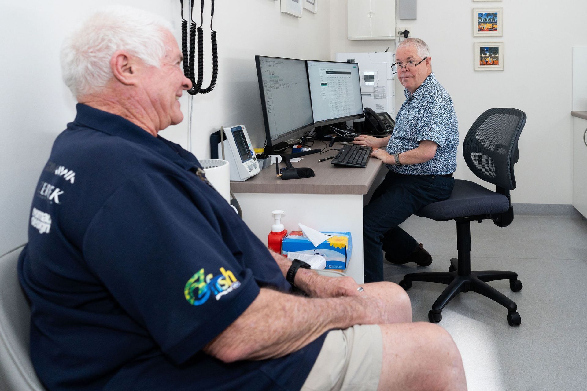 Doctor and patient in office, doctor at computer, patient seated. — Tewantin Medical Centre In Tewantin, QLD