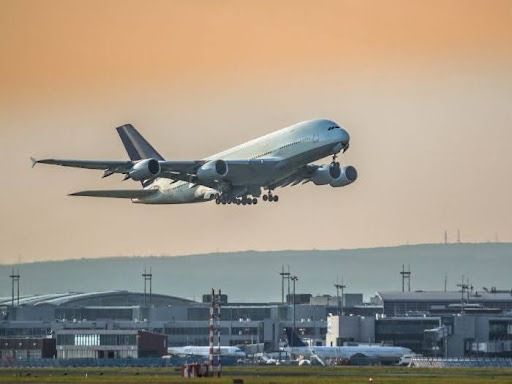 Large Passenger Airplane Taking Off From an Airport With a Sunset Background — Tewantin Medical Centre In Tewantin, QLD