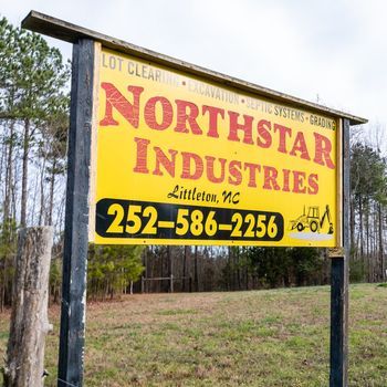 A yellow sign for northstar industries in littleton nc