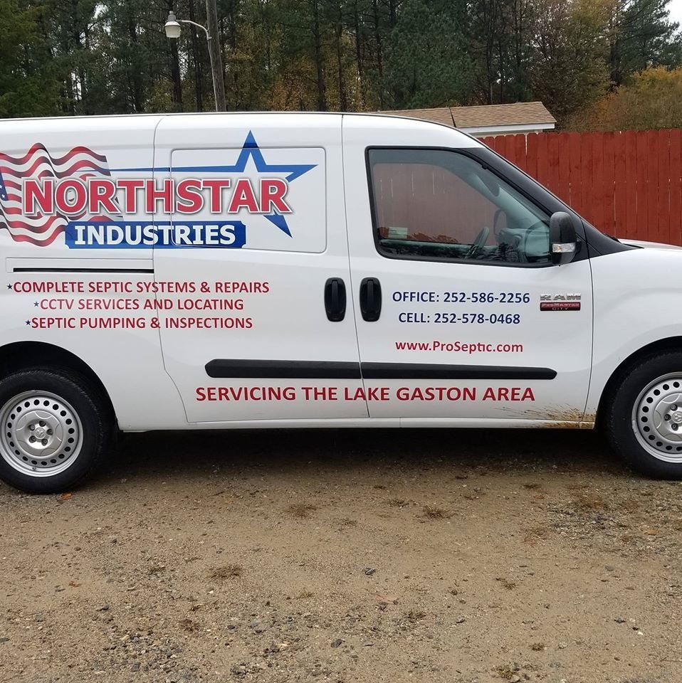 A white northstar industries van is parked in the dirt