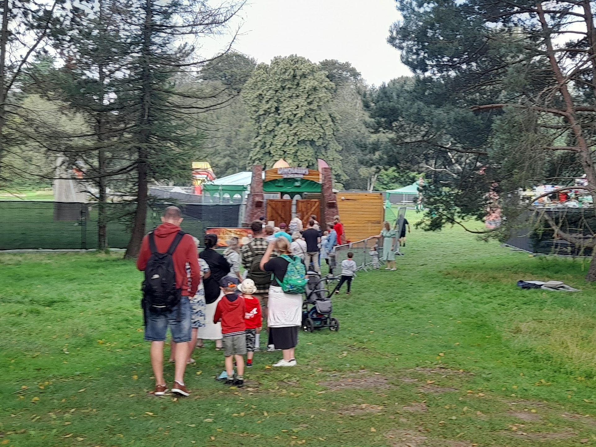 A group of people are standing in a grassy field.