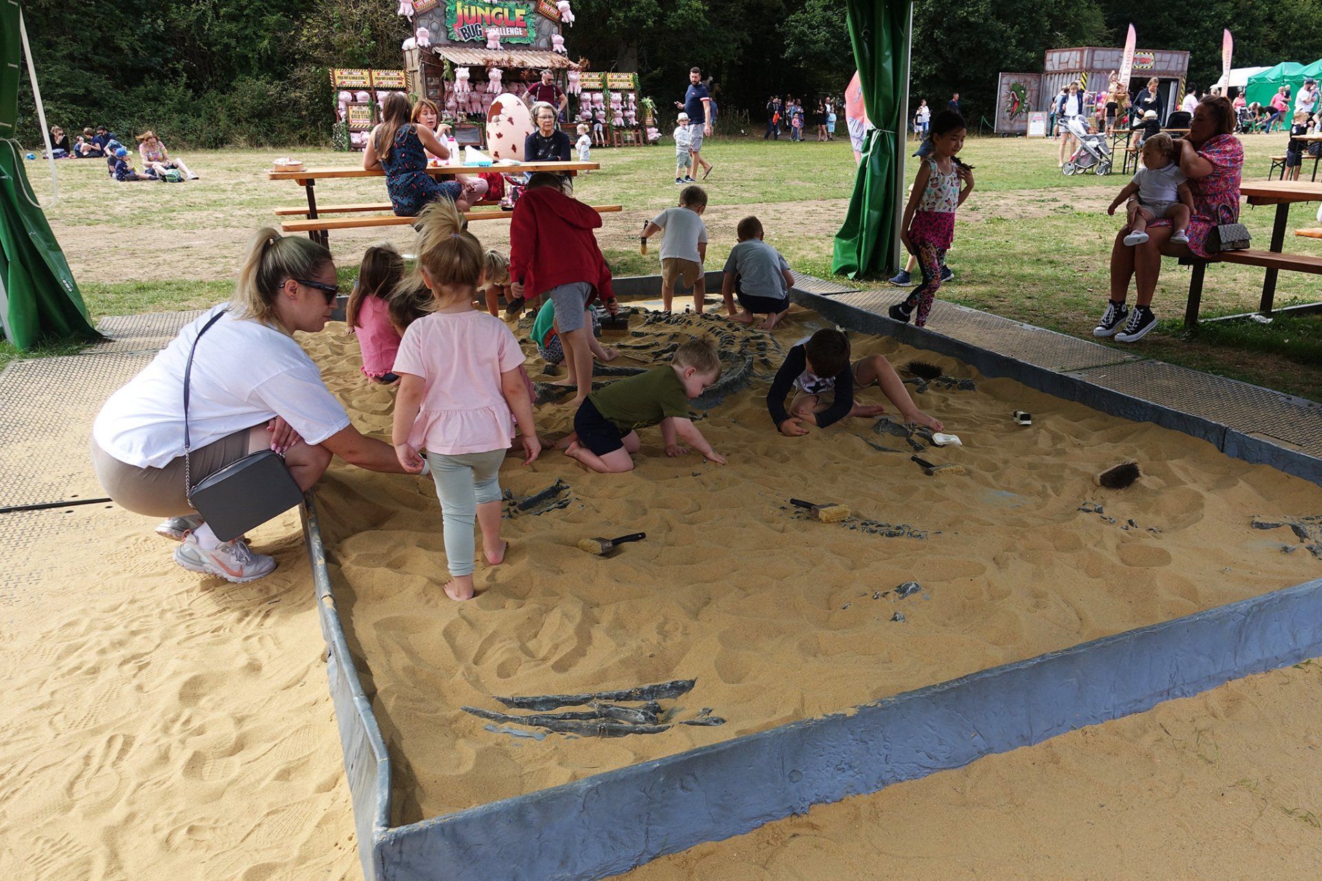 A group of children are playing in a sandbox.
