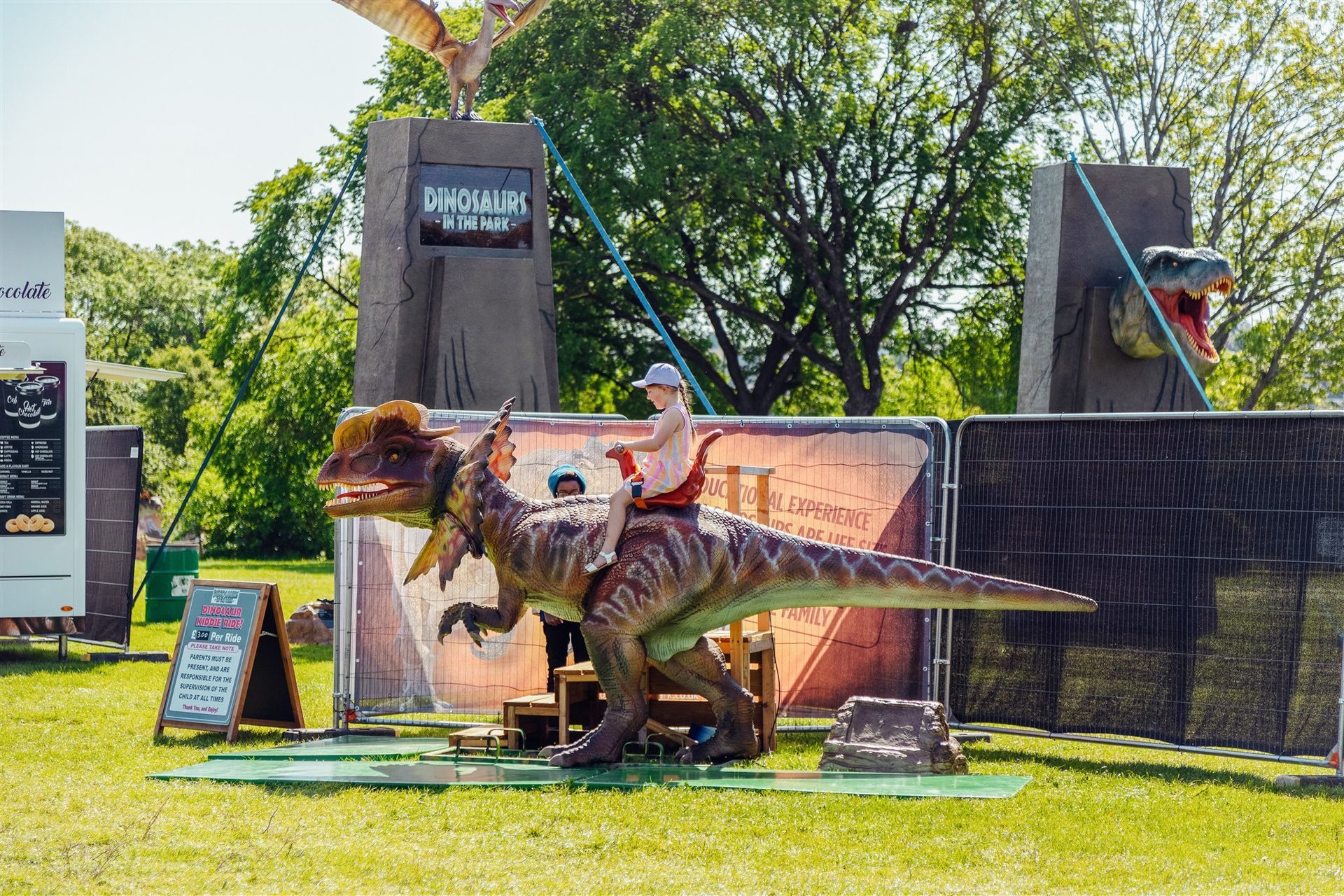 A man is riding on the back of a dinosaur.