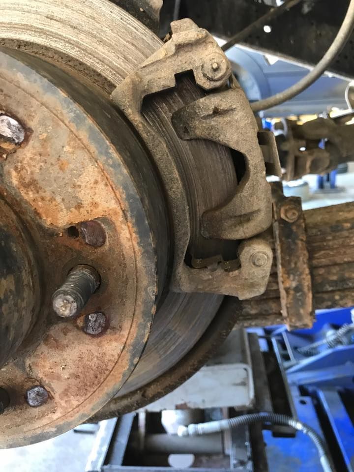 A Close Up of a Rusty Brake Caliper on a Truck — Zilzie Workshop In Emu Park, QLD