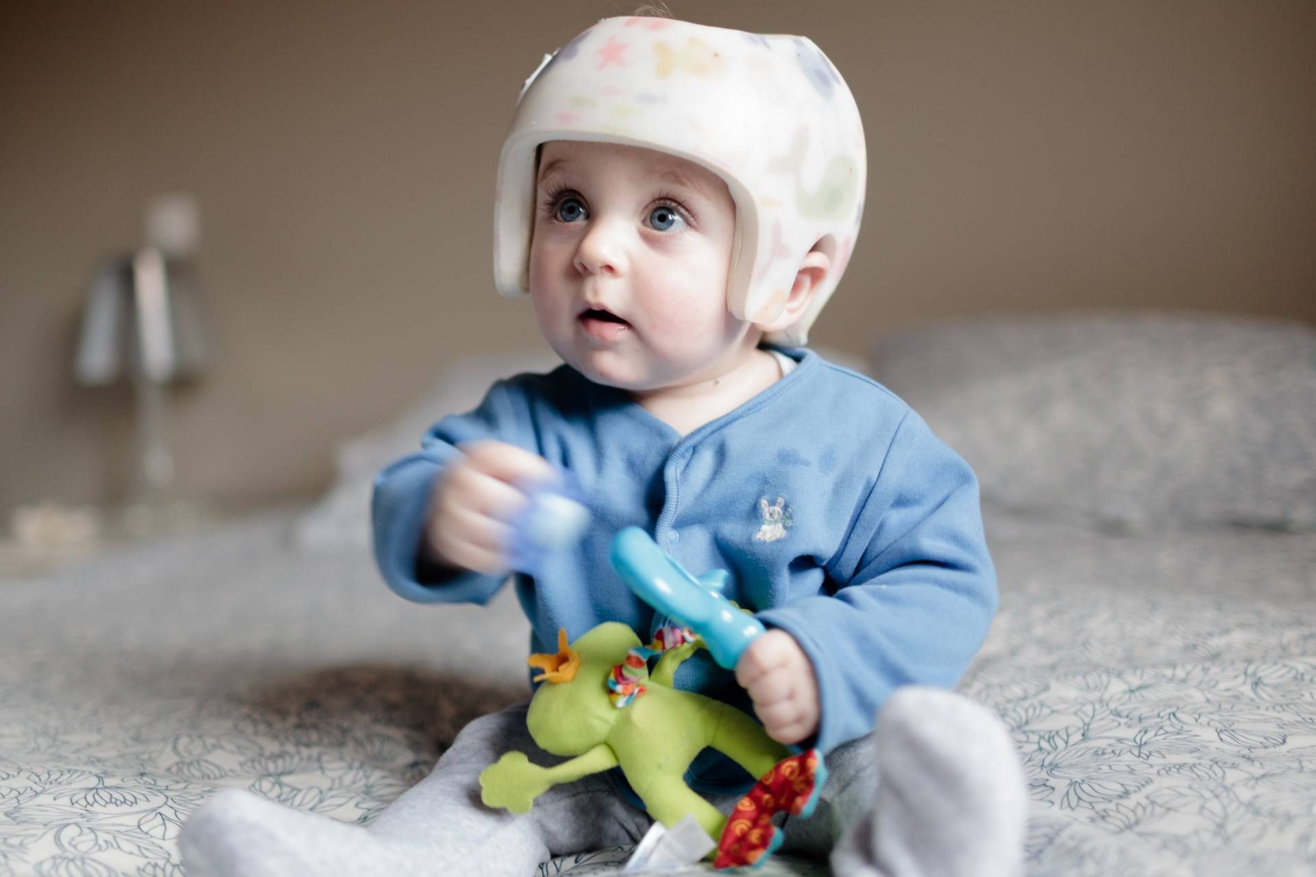 A baby wearing a cranial remolding helmet from Kenney Orthopedic near Lexington, Kentucky (KY)