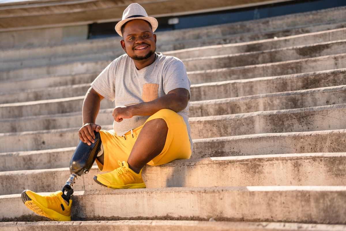 An individual sitting on stairs with a leg prosthetic near Lexington, Kentucky (KY)