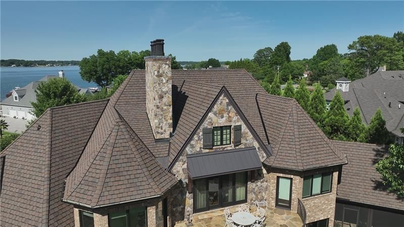 A close up of a black roof with a screw in it.