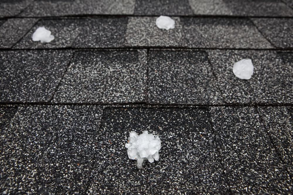 A black and white photo of hail on a roof.