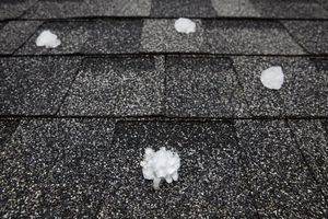 A black and white photo of hail on a roof.