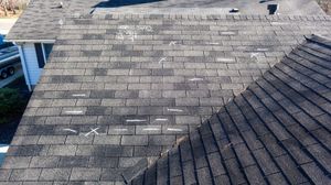 A close up of a roof with a lot of shingles on it.